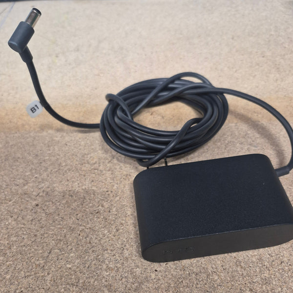 Black power adapter with cable on a textured surface